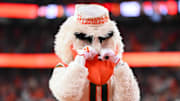 The Miami mascot, Sebastian, makes a crying gesture, and the Hurricanes may be feeling similar emotions as they sit on the College Football Playoff bubble.