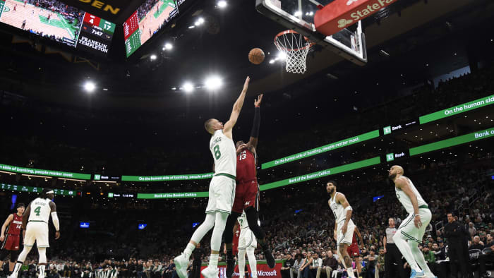 Apr 21, 2024; Boston, Massachusetts, USA; Miami Heat center Bam Adebayo (13) shoots the ball over Kristaps Porzingis.