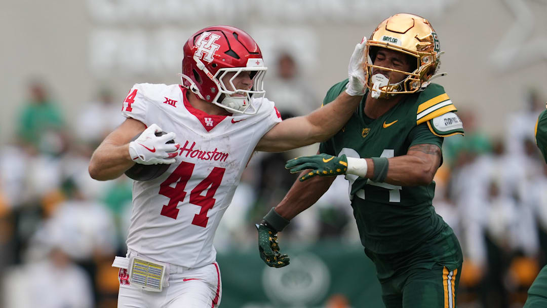 Houston Cougars running back Dean Connors (44) carries the ball against Baylor Bears safety Micah Gifford (24) during the second half at McLane Stadium. 