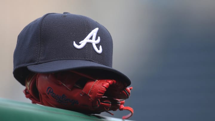 Jun 4, 2019; Pittsburgh, PA, USA;  An Atlanta Braves hat and glove sit on the dugout rail before the game against the Pittsburgh Pirates at PNC Park. Atlanta won 12-5. Mandatory Credit: Charles LeClaire-Imagn Images