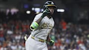 Athletics center fielder Lawrence Butler rounds the bases after hitting a home run during the ninth inning.