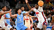 Mar 21, 2025; Milwaukee, WI, USA; North Carolina Tar Heels guard Elliot Cadeau (3) and Mississippi Rebels forward Malik Dia (0) chase a loose ball during the second half of a first round NCAA men’s tournament game at Fiserv Forum. Mandatory Credit: Benny Sieu-Imagn Images