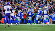 Nov 30, 2025; Seattle, Washington, USA; Seattle Seahawks linebacker Ernest Jones IV (13) runs back for an interception during the first half against the Minnesota Vikings at Lumen Field.