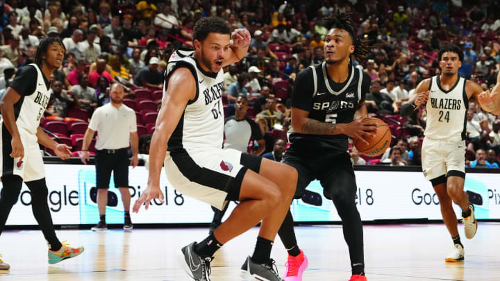 Jul 13, 2024; Las Vegas, NV, USA; San Antonio Spurs guard Stephon Castle (5) is fouled by Portland Trail Blazers forward Alex Reese (64) during the second quarter at Thomas & Mack Center. 