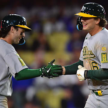 May 13, 2025; Los Angeles, California, USA; Athletics first baseman Nick Kurtz (16) is greeted by shortstop Jacob Wilson (5) after hitting a solo home run against the Los Angeles Dodgers during the eighth inning at Dodger Stadium. Mandatory Credit: Gary A. Vasquez-Imagn Images