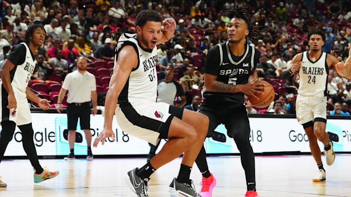 Jul 13, 2024; Las Vegas, NV, USA; San Antonio Spurs guard Stephon Castle (5) is fouled by Portland Trail Blazers forward Alex Reese (64) during the second quarter at Thomas & Mack Center.