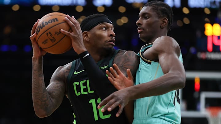 Boston Celtics forward Torrey Craig (12) looks to pass, defended by Charlotte Hornets forward Moussa Diabate (14) during the first half at TD Garden.