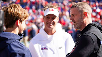 Florida Gators head coach Billy Napier talks with Mississippi Rebels head coach Lane Kiffin