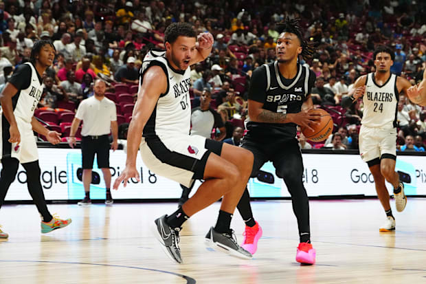 San Antonio Spurs guard Stephon Castle (5) is fouled by Portland Trail Blazers forward Alex Reese (64).