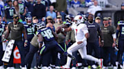 Nov 9, 2025; Seattle, Washington, USA; Arizona Cardinals quarterback Jacoby Brissett (7) rushes as Seattle Seahawks linebacker Tyrice Knight (48) defends during the second quarter at Lumen Field. Mandatory Credit: Kevin Ng-Imagn Images