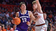 Jan 26, 2025; Champaign, Illinois, USA;  Northwestern Wildcats guard Brooks Barnhizer (13) drives the ball against Illinois Fighting Illini guard Kasparas Jakucionis (32) during the second half at State Farm Center. Mandatory Credit: Ron Johnson-Imagn Images