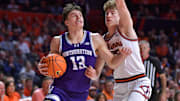 Jan 26, 2025; Champaign, Illinois, USA;  Northwestern Wildcats guard Brooks Barnhizer (13) drives the ball against Illinois Fighting Illini guard Kasparas Jakucionis (32) during the second half at State Farm Center. Mandatory Credit: Ron Johnson-Imagn Images