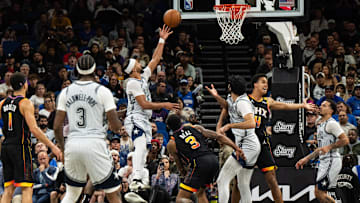 Dec 8, 2024; Orlando, Florida, USA; Orlando Magic guard Jalen Suggs (4) lays the ball in over Phoenix Suns forward Iso Ighodaro (4) in the fourth quarter at Kia Center. Mandatory Credit: Jeremy Reper-Imagn Images