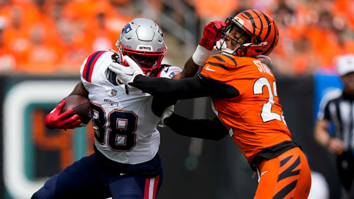 New England Patriots running back Rhamondre Stevenson (38) breaks a tackle from Cincinnati Bengals safety Geno Stone (22) on a carry in the first quarter of the NFL Week 1 game between the Cincinnati Bengals and the New England Patriots at Paycor Stadium in downtown Cincinnati on Sunday, Sept. 8, 2024.