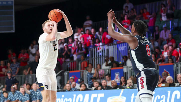 Nov 29, 2024; Paradise Island, Bahamas, BHS;  West Virginia Mountaineers guard Tucker DeVries (12) shoots over Arizona Wildcats guard Jaden Bradley (0) during the second half at Imperial Arena at the Atlantis resort.  Mandatory Credit: Kevin Jairaj-Imagn Images