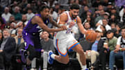 Nov 7, 2025; Sacramento, California, USA; Oklahoma City Thunder guard Ajay Mitchell (25) dribbles past Sacramento Kings guard Malik Monk (0) in the third quarter at the Golden 1 Center. Mandatory Credit: Cary Edmondson-Imagn Images