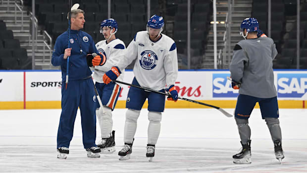 Hockey coach talks to player