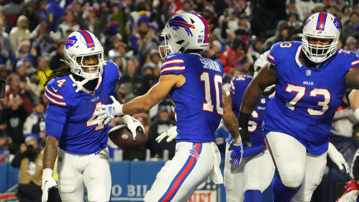 Dec 17, 2023; Orchard Park, NY; Buffalo Bills running back James Cook (4) celebrates a touchdown with Buffalo Bills wide receiver Khalil Shakir (10) in the first half against the Dallas Cowboys at Highmark Stadium.