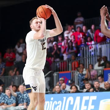 Mountaineers guard Tucker DeVries (12) shoots over Arizona Wildcats guard Jaden Bradley (0) during the second half at Imperial Arena at the Atlantis resort.