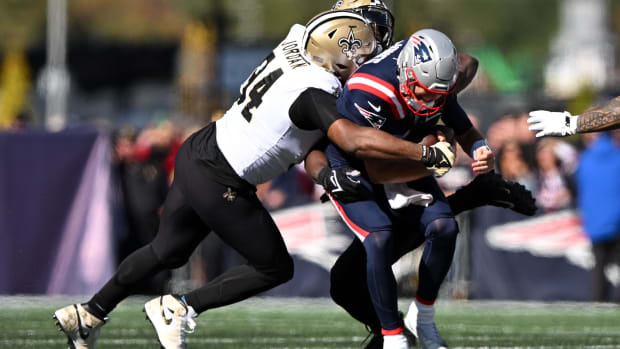 New England Patriots quarterback Mac Jones (10) is sacked by New Orleans Saints defensive end Cameron Jordan (94) 