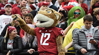 Oct 23, 2021; Pullman, Washington, USA; Washington State Cougars mascot Butch stand with the student section during a game against the Brigham Young Cougars in the first half at Gesa Field at Martin Stadium. Mandatory Credit: James Snook-Imagn Images