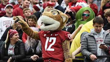 Oct 23, 2021; Pullman, Washington, USA; Washington State Cougars mascot Butch stand with the student section during a game against the Brigham Young Cougars in the first half at Gesa Field at Martin Stadium. Mandatory Credit: James Snook-Imagn Images