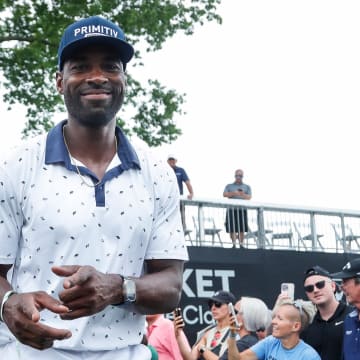 Calvin Johnson walks through the crowd after finish playing during AREA 313 Celebrity Scramble at Detroit Golf Club 