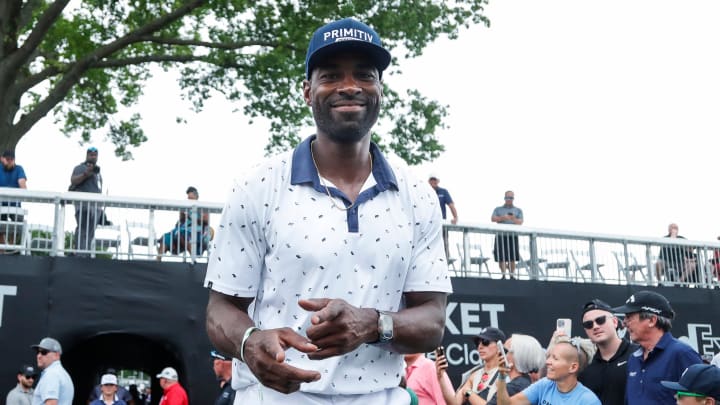 Calvin Johnson walks through the crowd after finish playing during AREA 313 Celebrity Scramble at Detroit Golf Club 