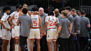 Dec 7, 2024; Coral Gables, Florida, USA; Miami Hurricanes head coach Jim Larranaga talks to his players during a timeline against the Clemson Tigers in the first half at Watsco Center. Mandatory Credit: Sam Navarro-Imagn Images