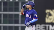 Texas Rangers right fielder Alejandro Osuna (19) reacts after hitting a double during the second inning against the Houston Astros at Daikin Park. 