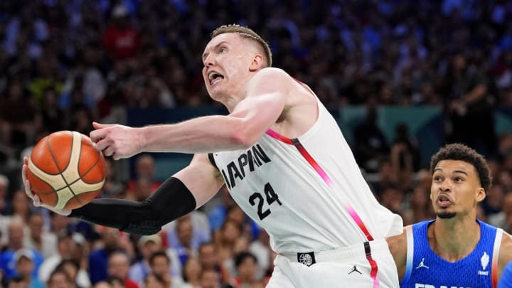 Jul 30, 2024; Villeneuve-d'Ascq, France; Japan centre Josh Hawkinson (24) grabs a rebound against France power forward Victor Wembanyama (32) in men’s basketball group B play during the Paris 2024 Olympic Summer Games at Stade Pierre-Mauroy. Mandatory Credit: John David Mercer-USA TODAY Sports