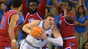 Nov 10, 2025; Los Angeles, California, USA;  UCLA Bruins forward Tyler Bilodeau (34) is defended by West Georgia Wolves guard Josh Smith (10), forward Kenneth Chime (22) and forward Xavier Shegog (3) as he goes up for a basket during the first half at Pauley Pavilion presented by Wescom Financial. Mandatory Credit: Jayne Kamin-Oncea-Imagn Images
