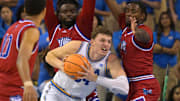 Nov 10, 2025; Los Angeles, California, USA;  UCLA Bruins forward Tyler Bilodeau (34) is defended by West Georgia Wolves guard Josh Smith (10), forward Kenneth Chime (22) and forward Xavier Shegog (3) as he goes up for a basket during the first half at Pauley Pavilion presented by Wescom Financial. Mandatory Credit: Jayne Kamin-Oncea-Imagn Images