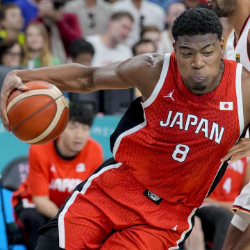 Jul 27, 2024; Villeneuve-d'Ascq, France; Japan small forward Rui Hachimura (8) pushes past Germany power forward Johannes Thiemann (32) during the Paris 2024 Olympic Summer Games at Stade Pierre-Mauroy. Mandatory Credit: John David Mercer-USA TODAY Sports