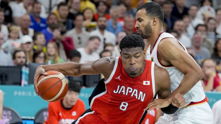 Jul 27, 2024; Villeneuve-d'Ascq, France; Japan small forward Rui Hachimura (8) pushes past Germany power forward Johannes Thiemann (32) during the Paris 2024 Olympic Summer Games at Stade Pierre-Mauroy. Mandatory Credit: John David Mercer-USA TODAY Sports