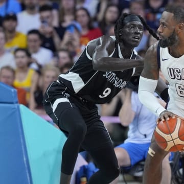 Jul 31, 2024; Villeneuve-d'Ascq, France; United States foward Lebron James (6) dribbles against South Sudan power forward Wenyen Gabriel (9) in the second quarter during the Paris 2024 Olympic Summer Games at Stade Pierre-Mauroy. Mandatory Credit: John David Mercer-USA TODAY Sports