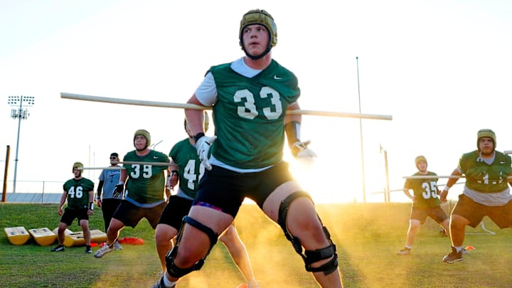 Basha offensive tackle Jake Hildebrand runs a drill during a practice at Basha High School on April 25, 2024.