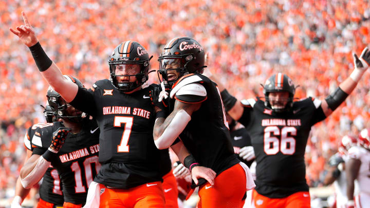 Oklahoma State's Alan Bowman (7) celebrates his touchdown with Ollie Gordon II (0) in the first half during a Bedlam college football game between the Oklahoma State University Cowboys (OSU) and the University of Oklahoma Sooners (OU) at Boone Pickens Stadium in Stillwater, Okla., Saturday, Nov. 4, 2023.