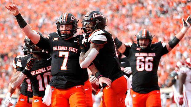 Oklahoma State Cowboys quarterback Alan Bowman celebrates a touchdown during a college football game in the Big 12.