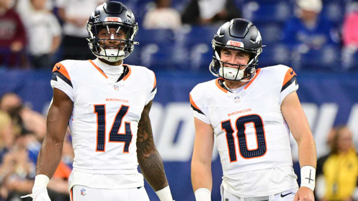 Aug 11, 2024; Indianapolis, Indiana, USA; Denver Broncos wide receiver Courtland Sutton (14) and quarterback Bo Nix (10) stand on the field during warm ups before the game against the Indianapolis Colts at Lucas Oil Stadium. 