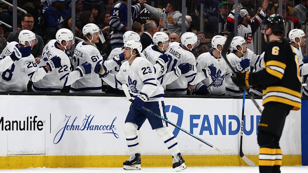 Mar 24, 2026; Boston, Massachusetts, USA; As Boston Bruins defenseman Mason Lohrei (6) heads for his bench, Toronto Maple Leafs left wing Matthew Knies (23) is congratulated at the bench after scoring a shorthanded goal during the second period at TD Garden. Mandatory Credit: Winslow Townson-Imagn Images