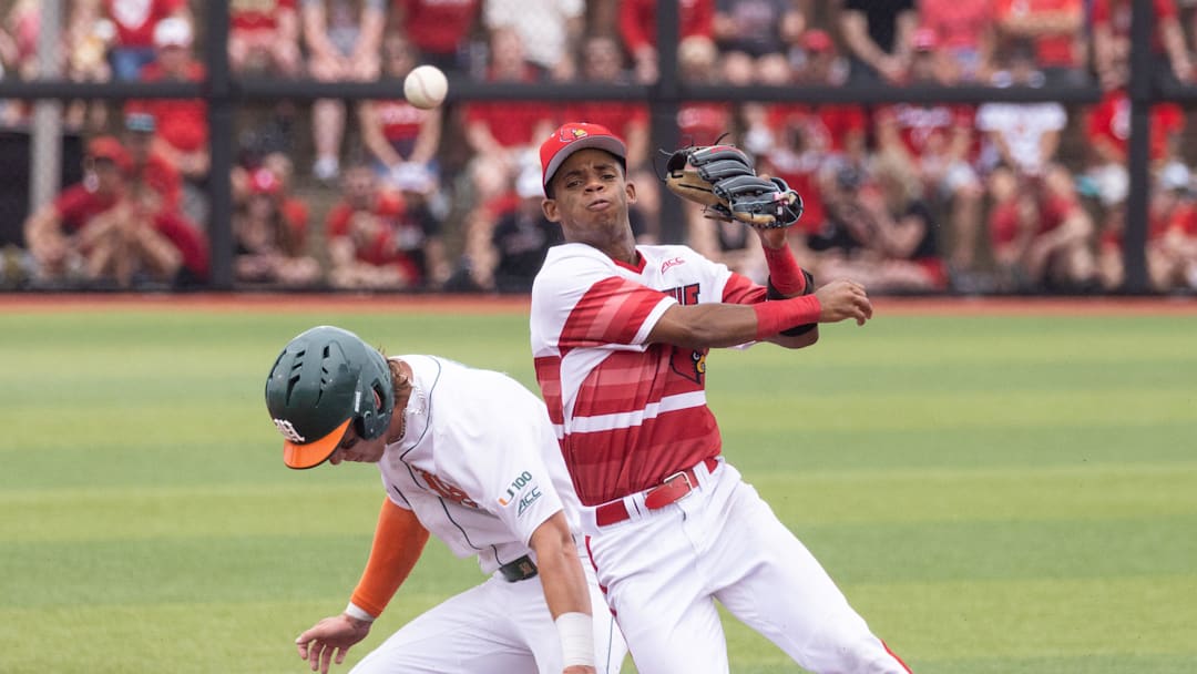 Louisville infielder Kamau Neighbors beats Miami infielder Jake Ogden and throws to first during the NCAA baseball Super Regional game 2 at Jim Patterson Stadium on June 7, 2025 in Louisville, Ky.