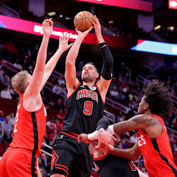 ; Chicago Bulls center Nikola Vucevic (9) shoots against Houston Rockets center Jock Landale (2) during the first quarter at Toyota Center. Mandatory Credit: Erik Williams-Imagn Images