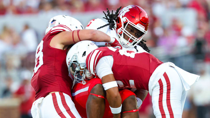 Sep 7, 2024; Norman, Oklahoma, USA;  Oklahoma Sooners defensive back Peyton Bowen (22) and Oklahoma Sooners linebacker Danny Stutsman (28) tackle Houston Cougars wide receiver Stephon Johnson (5) during the first quarter at Gaylord Family-Oklahoma Memorial Stadium. 