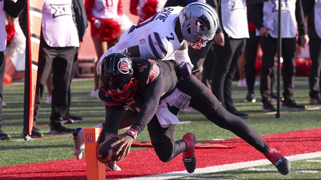 Nov 22, 2025; Salt Lake City, Utah, USA; Utah Utes quarterback Devon Dampier (4) reaches for a touchdown against Kansas State Wildcats safety Vj Payne (7) during the first half at Rice-Eccles Stadium. Mandatory Credit: Rob Gray-Imagn Images Nov 22, 2025; Salt Lake City, Utah, USA; Utah Utes quarterback Devon Dampier (4) reaches for a touchdown against Kansas State Wildcats safety Vj Payne (7) during the first half at Rice-Eccles Stadium. Mandatory Credit: Rob Gray-Imagn Images