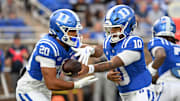 Nov 15, 2025; Durham, North Carolina, USA; Duke Blue Devils quarter back Darian Mensah (10) hands the ball to Duke Blue Devils running back Nate Sheppard (20) against the Virginia Cavaliers during the first quarter at Wallace Wade Stadium. Mandatory Credit: Zachary Taft-Imagn Images