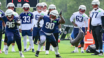 Jul 27, 2023; Foxborough, MA, USA; New England Patriots defensive tackle Christian Barmore (90) throws a weight bag during training camp at Gillette Stadium. Mandatory Credit: Eric Canha-Imagn Images