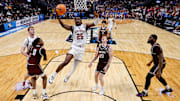 Mar 20, 2025; Denver, CO, USA; Wisconsin Badgers guard John Blackwell (25) drives to the net as Montana Grizzlies guard Money Williams (0) defends against forward Steven Crowl (22) and guard Austin Patterson (20) and forward Te'Jon Sawyer (32) defend in the first half at Ball Arena.