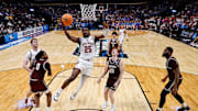 Mar 20, 2025; Denver, CO, USA; Wisconsin Badgers guard John Blackwell (25) drives to the net as Montana Grizzlies guard Money Williams (0) defends against forward Steven Crowl (22) and guard Austin Patterson (20) and forward Te'Jon Sawyer (32) defend in the first half at Ball Arena.
