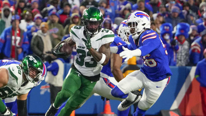 Nov 19, 2023; Orchard Park, New York, USA; New York Jets running back Dalvin Cook (33) runs with the ball Buffalo Bills defensive end Leonard Floyd (56) during the first half at Highmark Stadium. Mandatory Credit: Gregory Fisher-USA TODAY Sports